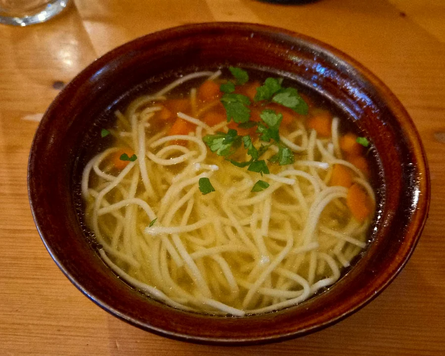 Noodle soup in a brown bowl
